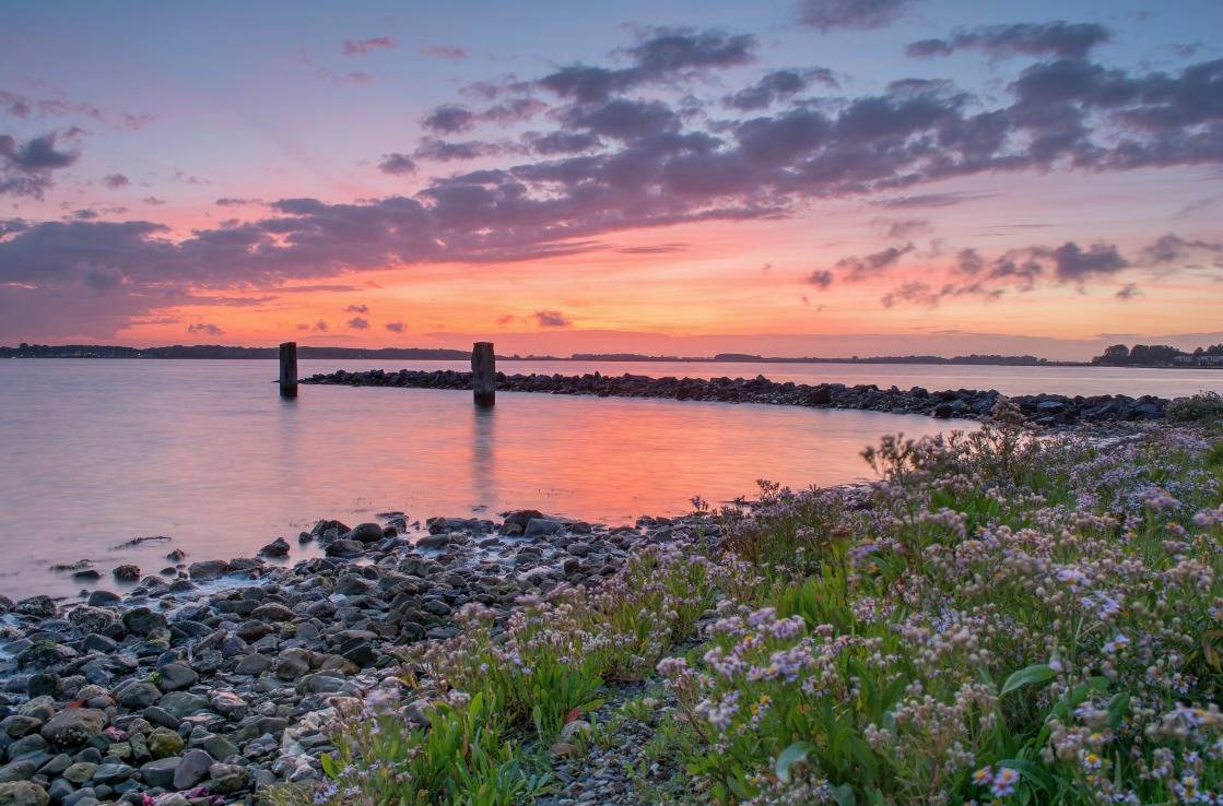 Stone pier on the Veerse Meer lagoon, at sunset. Stone pier on the Veerse Meer lagoon, at sunset.