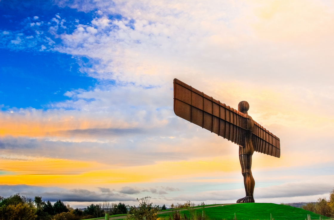 Sculpture of a man with aeroplane wings for arms stands on the top of a hill. Sculpture of a man with aeroplane wings for arms stands on the top of a hill.