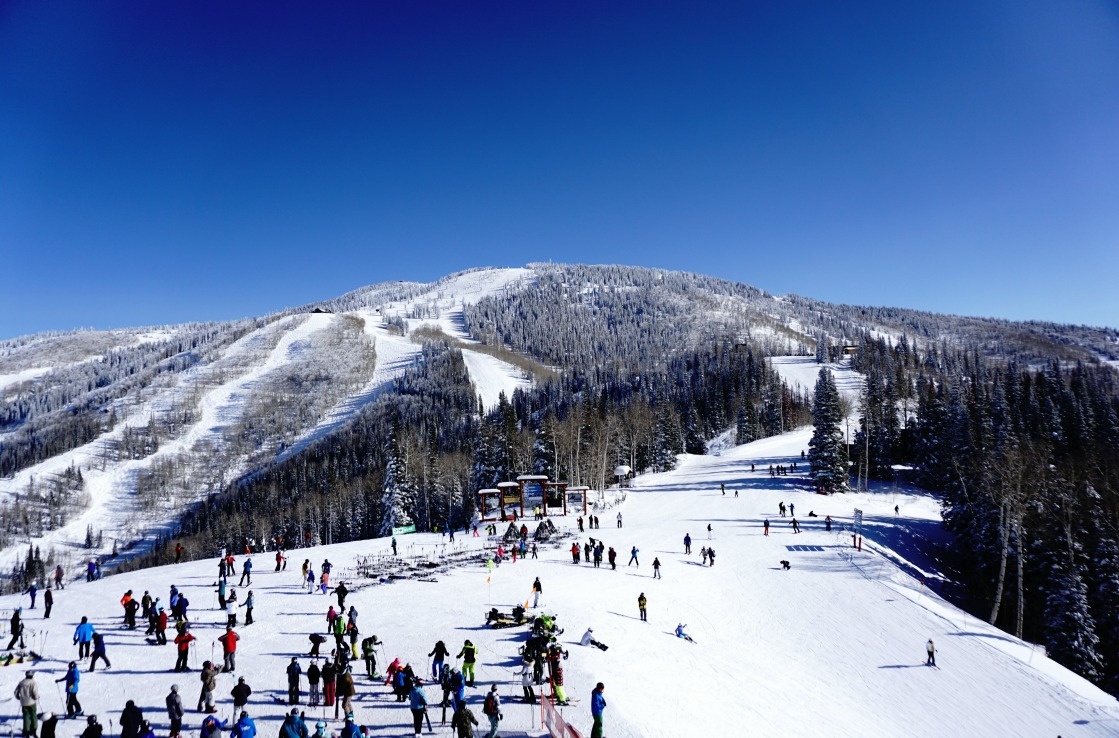 Various people skiing on the top of a snowy mountain. Various people skiing on the top of a snowy mountain.