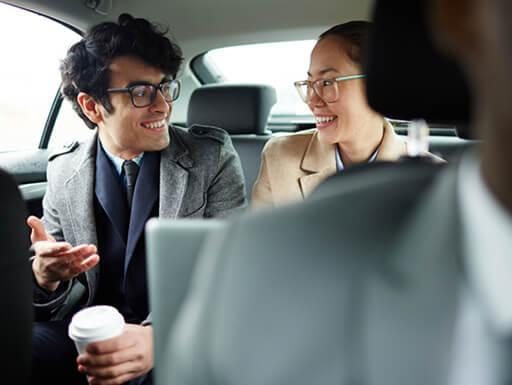 two-passengers-conversing-in-back-of-car