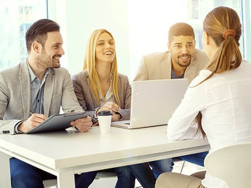 Three people interviewing a woman