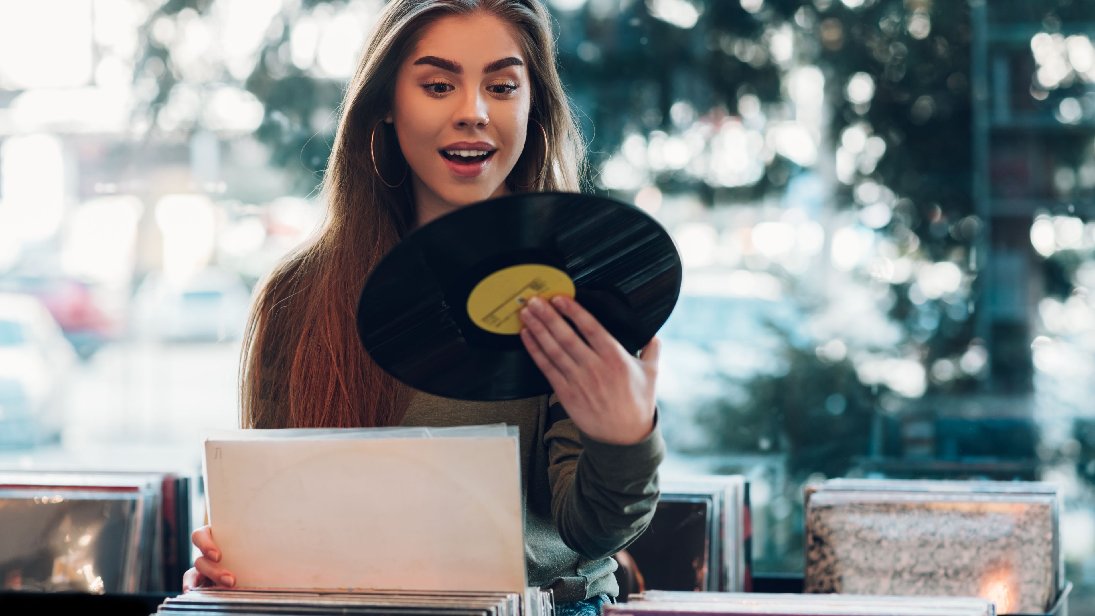Woman staring at vinyl record Woman staring at vinyl record