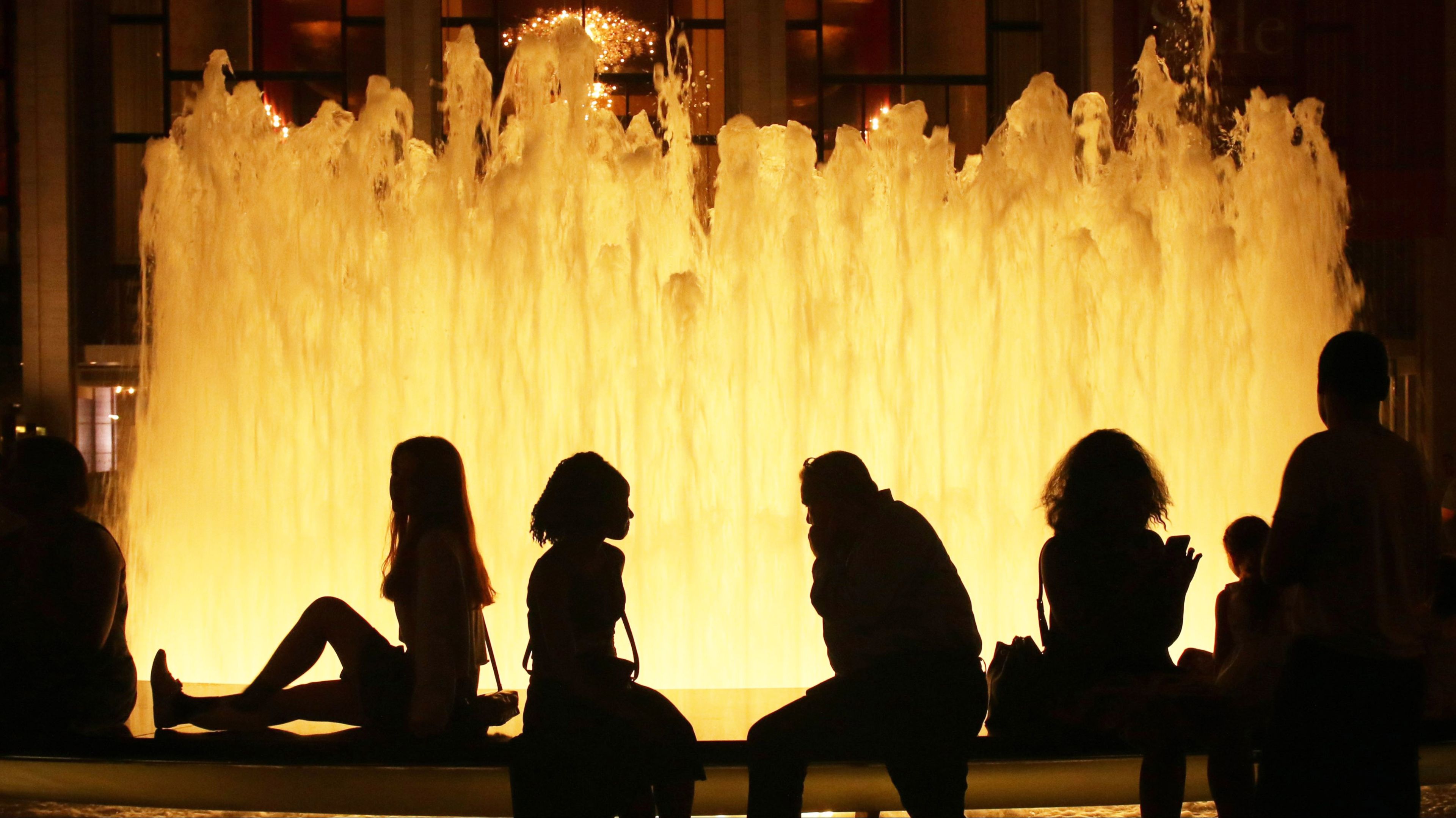 people sitting at the fountain of the Lincoln Center people sitting at the fountain of the Lincoln Center