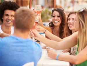 Group of friends cheering with glasses of wine Group of friends cheering with glasses of wine