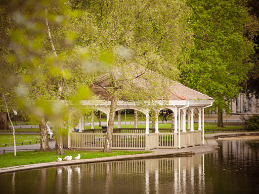 A quaint bandstand next to the lake in leafy St. Stephen’s Green Park on a sunny afternoon in Dublin, Ireland. A quaint bandstand next to the lake in leafy St. Stephen’s Green Park on a sunny afternoon in Dublin, Ireland.