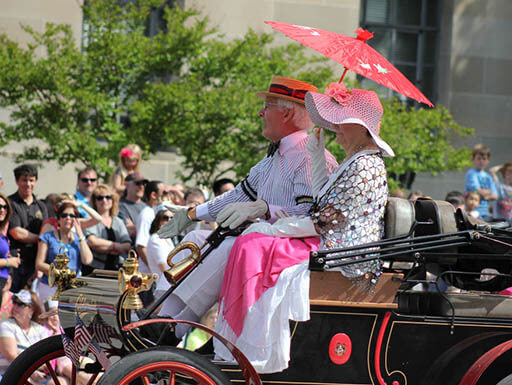 Two people on a float in the National Cherry Blossom Festival Parade in 2012 Two people on a float in the National Cherry Blossom Festival Parade in 2012
