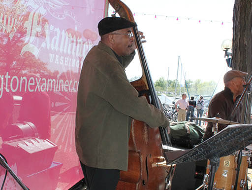 A man playing the cello as part of a band performance in April of 2012 A man playing the cello as part of a band performance in April of 2012