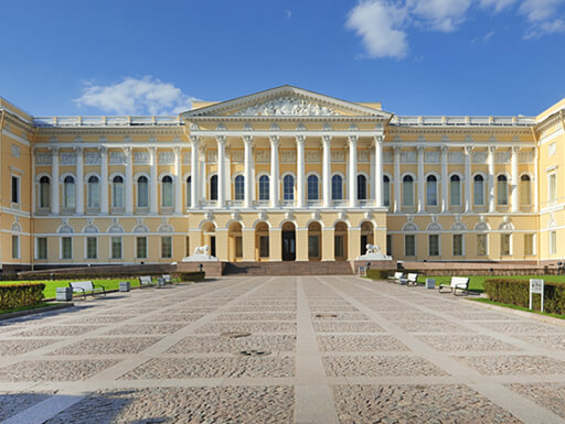 A view of the exterior of the State Russian Museum, an impressive yellow building, seen on a sunny afternoon in St. Petersburg, Russia. A view of the exterior of the State Russian Museum, an impressive yellow building, seen on a sunny afternoon in St. Petersburg, Russia.