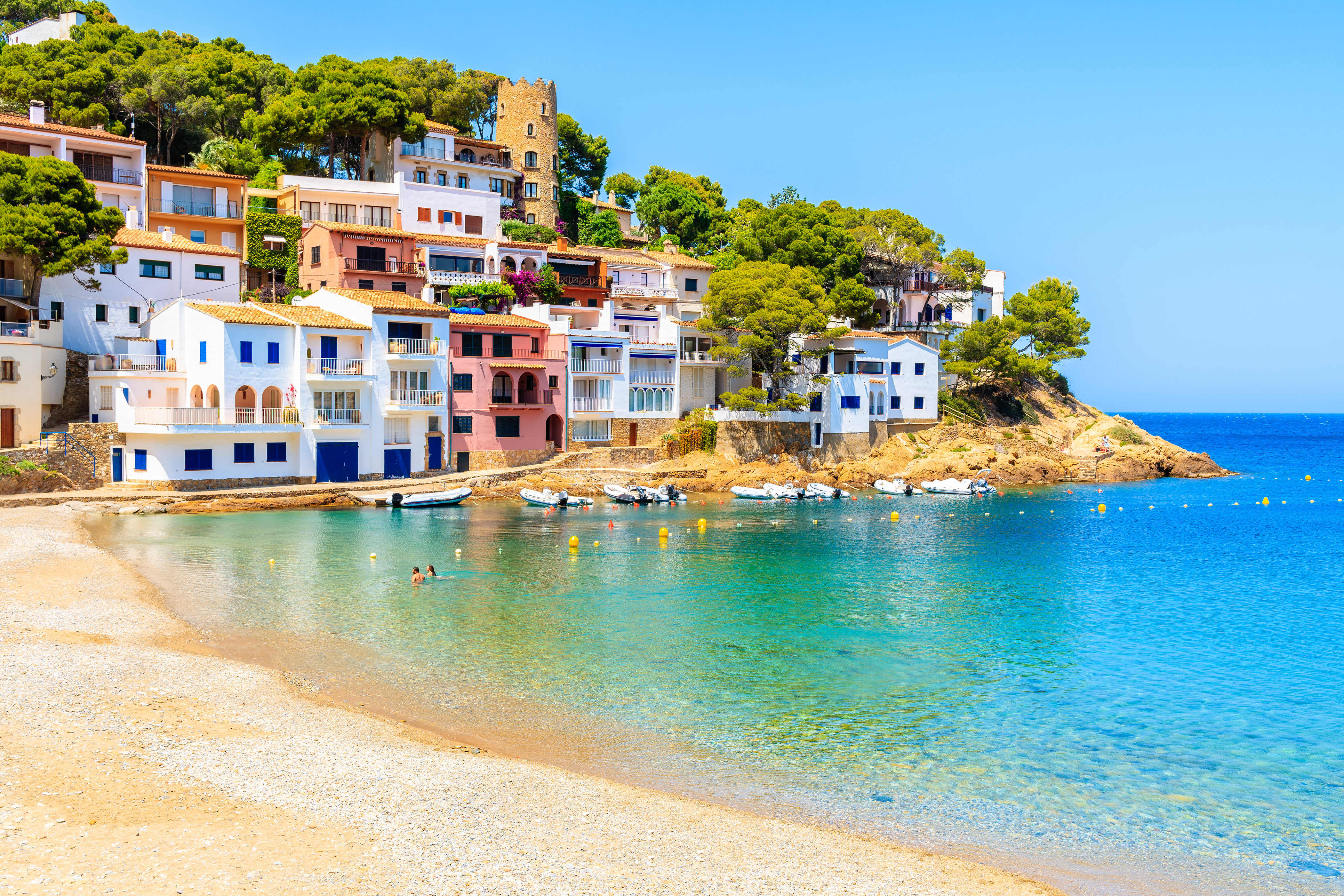 Colorful houses in sea bay with beach in Sa Tuna coastal village, Costa Brava, Spain beach house