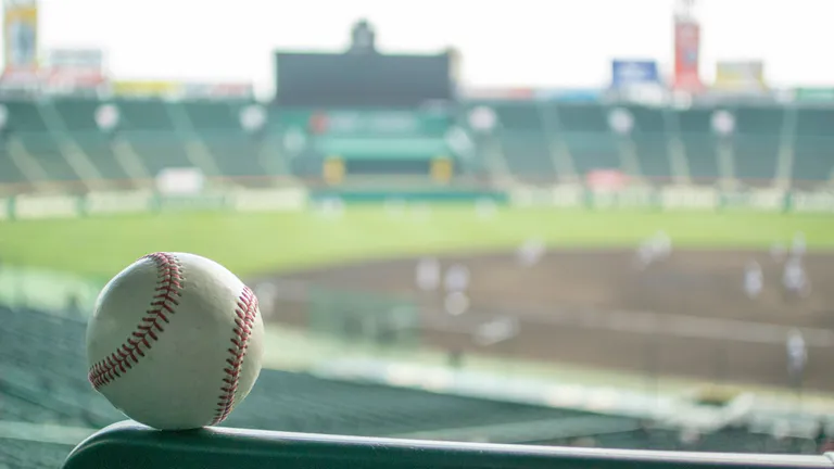 Baseball ball and pitch in the background