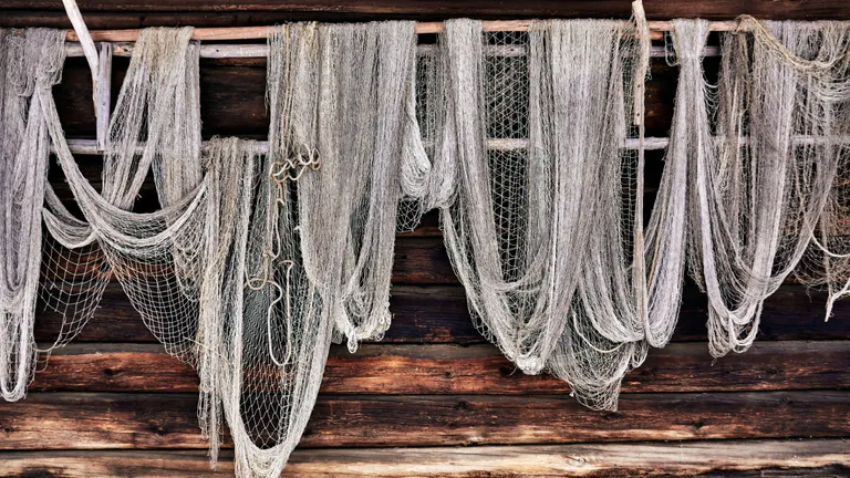 Fishing nets on wooden wall