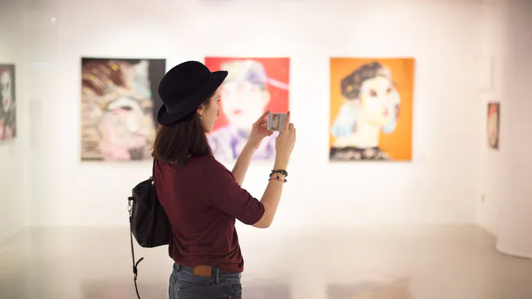 Woman looking at art in art gallery