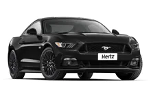 Black Ford Mustang on white background.
